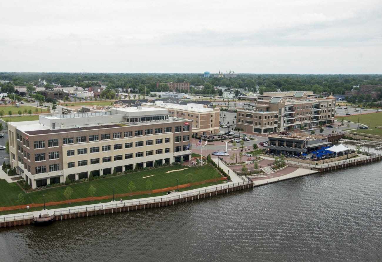 Bay City's Uptown development is seen from a Magnum Helicopters Robinson R-44 helicopter over the Saginaw River in Bay City on June 30, 2017.